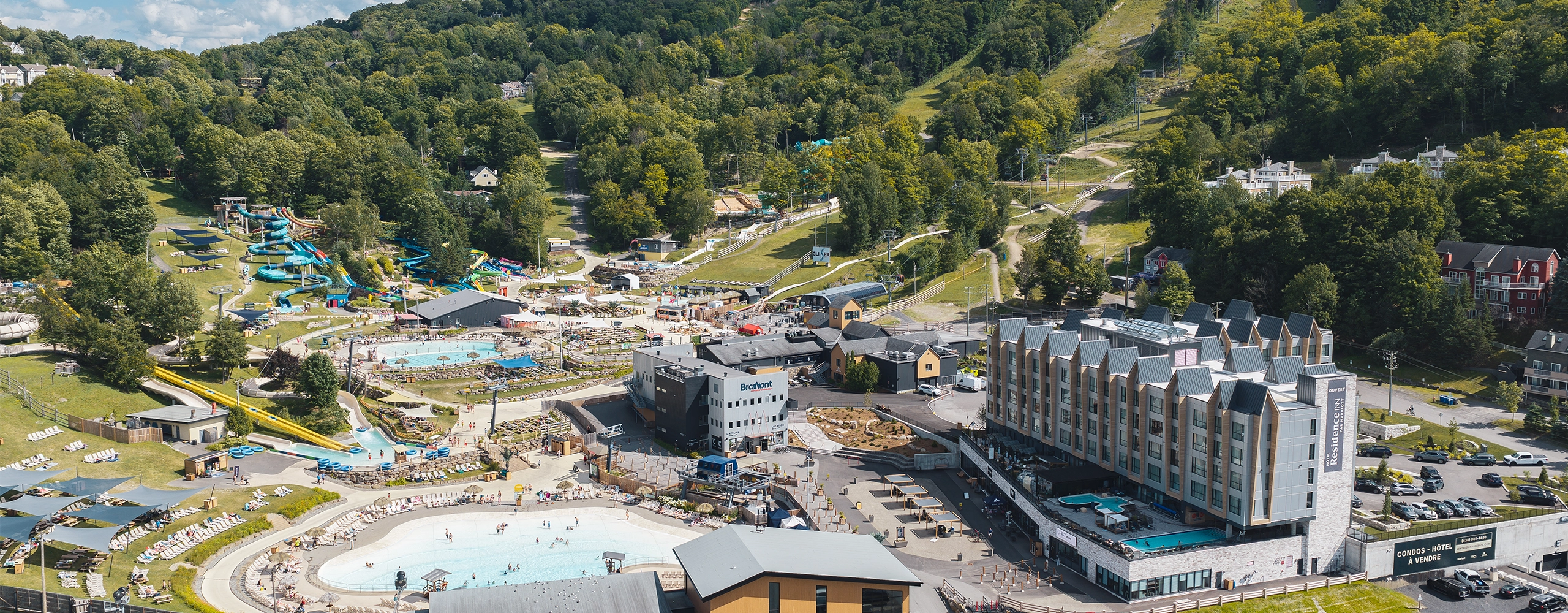 Birds eye view of Bromont, montagne d'expériences Water Park and hotel in the summer